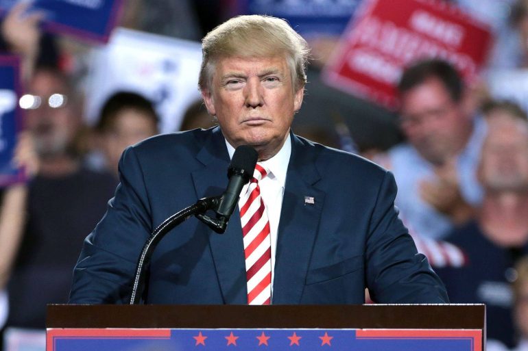 US President Donald Trump standing at podium