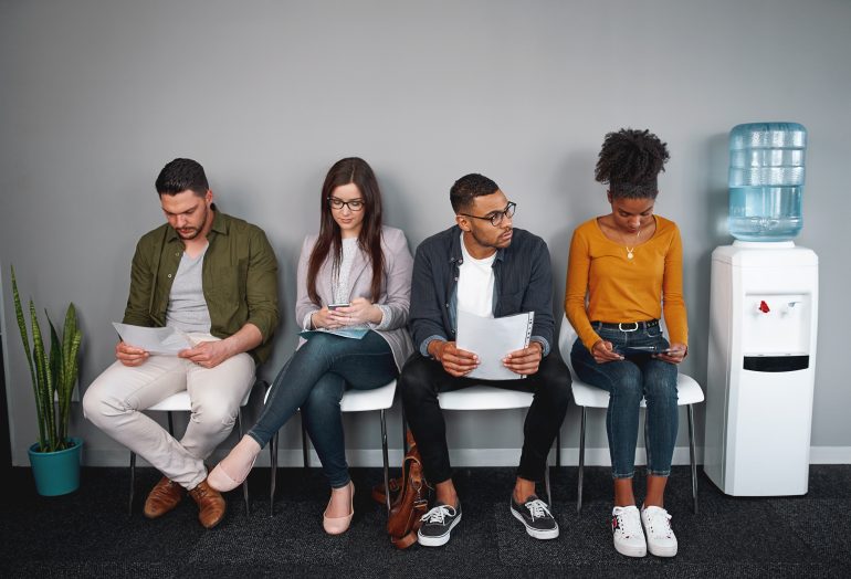 Multiethnic candidates waiting for the job interview competing for one position in office - diverse group of young adults applying for a job