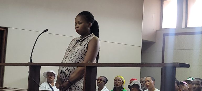 Keneilwe Shalaba standing in the dock in court