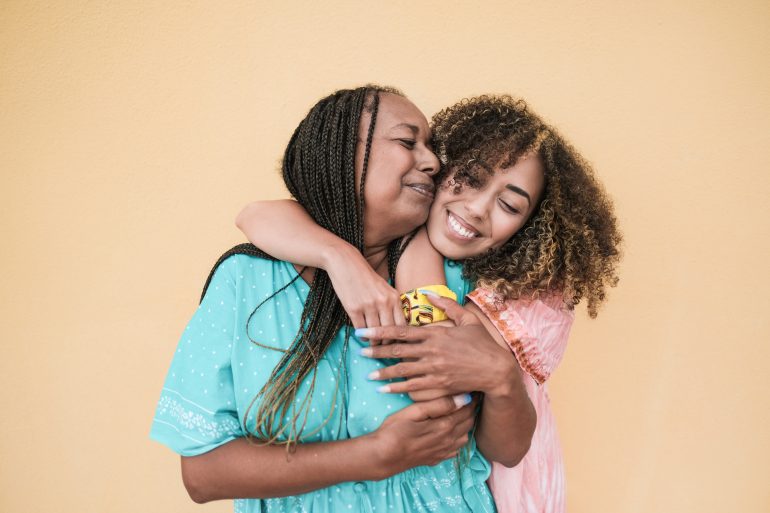 Mother and daughter embracing each other