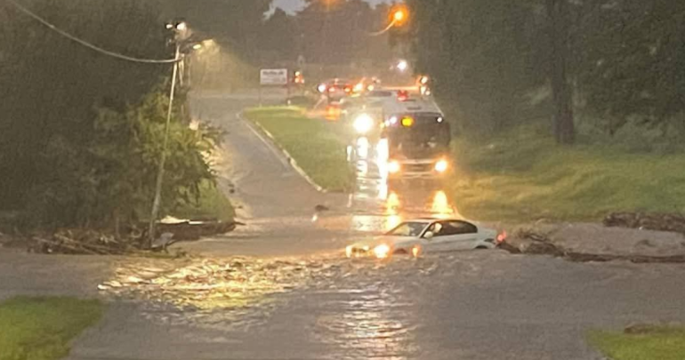 Car driving in bad weather/flooding on the road