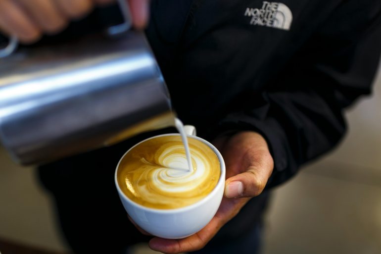 Barista preparing a cup of cappuccino